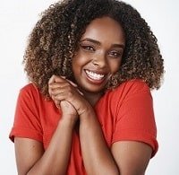 excited-overwhelmed-cute-amused-dark-skinned-womanfriend-red-t-shirt-smiling-broadly-pressing-palms-together-near-chest-standing-thrilled-thankful-awesome-gift-white-wall-min